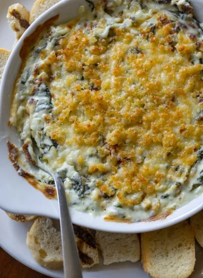 Baked spinach dip served with toasted bread slices (illustrative image)