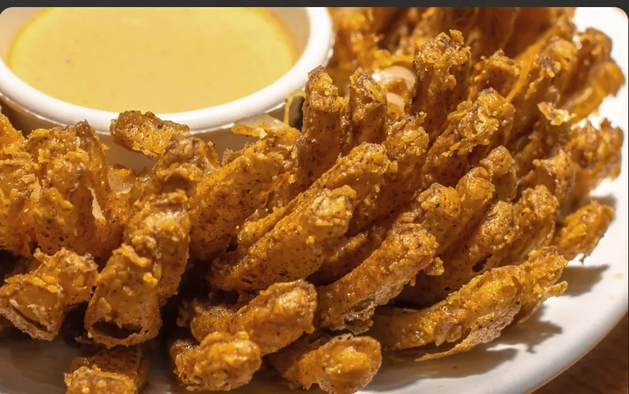 Crispy fried onion with a dipping sauce (illustrative image)