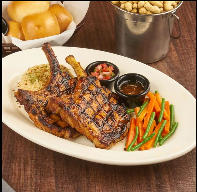 Grilled cowboy pork chops with rice and vegetables