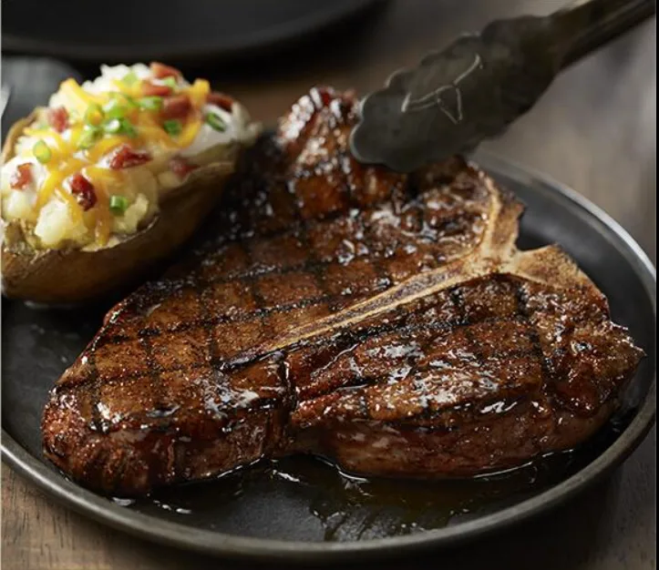 A grilled porterhouse steak with a loaded baked potato (illustrative image)
