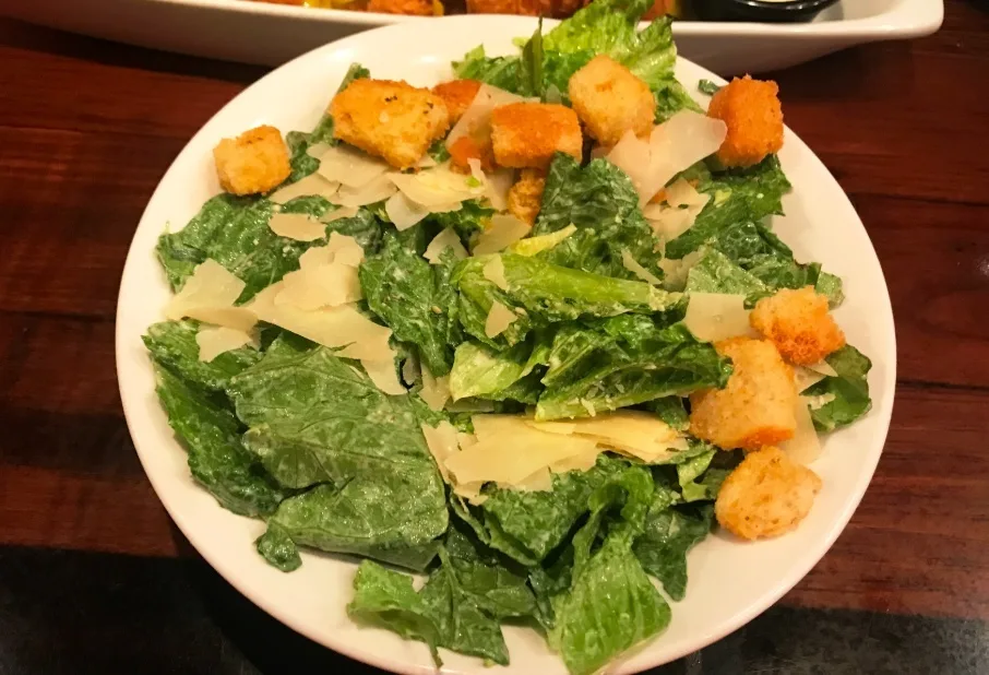 Caesar salad with croutons and shaved Parmesan (illustrative image)