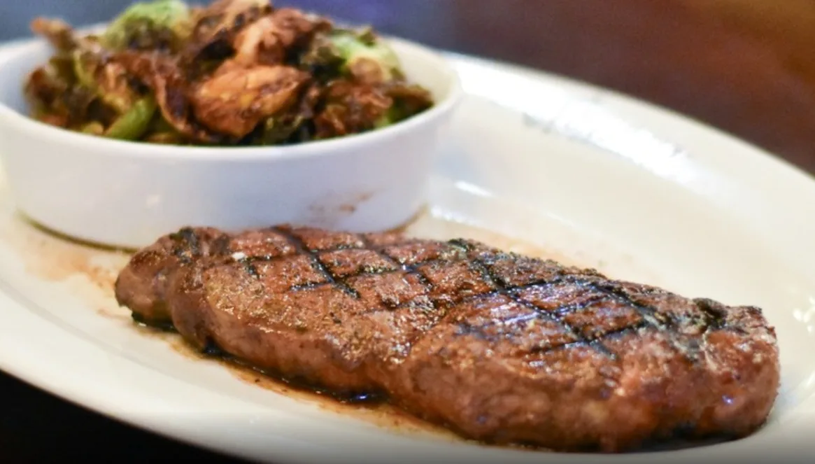 Grilled strip steak with crispy Brussels sprouts (illustrative image)