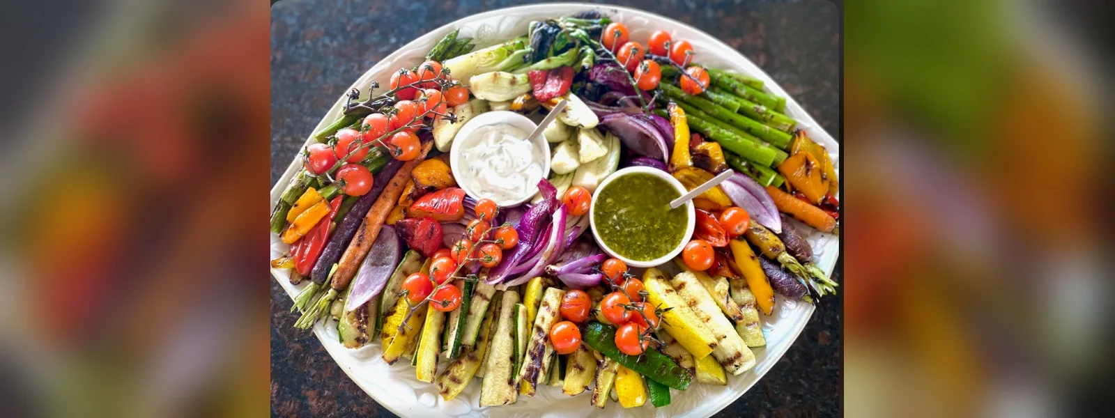 Platter of grilled and roasted vegetables with two dips (illustrative image)